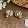 Close-up of vintage French horse-head stud earrings decorated with pearls and sparkly zircons - Horse Head Relief Style (HE33030) / Gold and Silver Two-tone