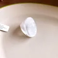 Close-up view showing the pearlescent texture of a chunky white resin ring with irregular wide band - Irregular Wide Band Style / White