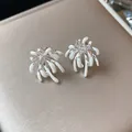Detailed macro shot of elegant zircon firework stud earrings with white enamel drip design - Silver & White (Silver Earring Post)