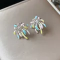 Close-up of colorful enamel firework stud earrings with zircon details on beige box. - Silver Needle-Silver-Colorful