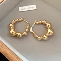 Elegant gold beaded hoop earrings featuring a shiny polished finish and minimalist design for women - Ear Buckle / Gold