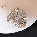 Close-up detail showing the metallic texture of silver pleated fan-shaped drop earrings. - Silver Post (HE33039) / Silver