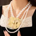 Elegant multi-layered pearl necklace with large hammered gold-tone metal pendant charm - Multi-layer Beaded Style / Gold/White