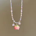 Close-up of sweet style beaded necklace with a preserved pink rose pendant detail - Necklace / Pink