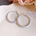 Detailed macro view of silver needle hoop earrings with vibrant colorful polka dots - Large / Silver Base With Colorful Polka Dots