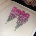 Detailed view of pink and silver rhinestone tassel earrings in a beige jewelry box - Silver Earring Post - Pink - Green