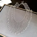 Close-up detail of elegant silver fringe necklace with crystal beads on gray display - Silver Chain - Clear Quartz