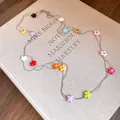 Detail shot of a long double-layered necklace with colorful resin flower charms - Double Layer Flower Long Style / Silver - Rainbow