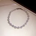 Close-up of elegant silver-tone leaf bracelet with sparkling marquise zircons in a jewelry box - Bracelet / Silver
