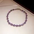 Detail of an elegant silver bracelet with purple marquise-cut zircons in a box - Bracelet / Silver Purple