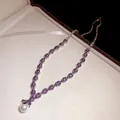 Elegant silver-toned necklace featuring purple zircons and a white pearl pendant. - Necklace / Silver Purple