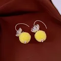 Close-up of elegant yellow crystal beaded sphere earrings on dark fabric background - Hook Style / Silver-Yellow
