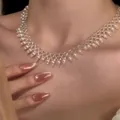 Close-up detail of a French vintage pearl beaded lace necklace on a model's neck - French Woven Lace Necklace / White