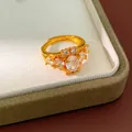 Close-up detail of a vintage palace style gold plated ring featuring shimmering oval zirconias - Adjustable Open / Gold