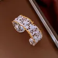 Close-up of two-tone hollow out lace cuff bracelet in gold and silver finish - Hollow Lace Bangle / Silver (HB6072)
