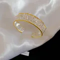 Elegant hollow lace cuff bracelet in two-tone gold and silver finish - Hollow Lace Bangle / Two-Tone Wide Style (HB6072)