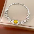 Close-up of elegant palace style bracelet with square yellow zircon centerpiece and floral accents - Bracelet (HB6034-1) / Fold Over Clasp / Yellow/Silver