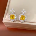 Detailed macro view of vintage square yellow zircon earrings featuring silver star designs - Drop Earrings (HE33980-1) / Stud Style / Yellow/Silver
