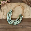 Detailed view of bohemian triple-layered shell bead necklace with adjustable gold chain - Gold-Blue