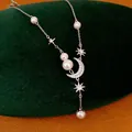 Detail of elegant star and moon pendant necklace with lustrous pearls and zircon - Necklace-Silver-White