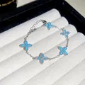 Delicate silver bracelet featuring blue four-leaf clover motifs with beaded edges - White-Green