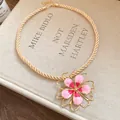 Detailed view of a vintage pink floral pendant necklace with a gold twisted rope chain. - Necklace / Pink