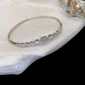 Detalle de brazalete geométrico bañado en oro de 14K con piedras de circonita. - 2# Pulsera-Plata