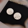 Detailed close-up of vintage 18k gold-plated round stud earrings with embossed texture. - Vintage Round Floral (HE32188) / Silver