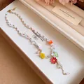 Close-up of candy color beaded necklace with colorful flower pendants in a jewelry box - Necklace / Colorful