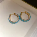 Close-up of vintage style hoop earrings with turquoise beads and pavé zircons - Hoop Ear Buckle / Blue