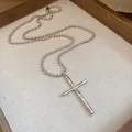 Detailed close-up of a vintage silver cross pendant on a classic beaded ball chain necklace - Silver