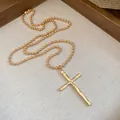 Detailed view of the vintage gold cross pendant with metallic ball chain necklace - Gold