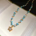 Close-up of vintage style pearl and blue stone beaded necklace with star pendant. - Beaded Necklace / Blue