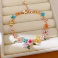 Detailed view of 18k gold plated bracelet featuring colorful zircon flowers and pearls. - Flower Butterfly Style / Gold-Multicolor