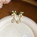 Detailed close-up of French retro enamel flower earrings with elegant hanging pearls. - Silver Earring Post Style / White Style