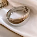 Close-up detail of a glossy silver minimalist wide hinged bangle bracelet - Wide Round Mirror Polish Bangle (2)