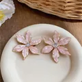 Detailed macro view of pink enamel flower stud earrings with central zircon stone - Flower Shape (HE32525) / Pink