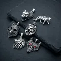 Macro view of several Nordic animal head pendants including a wolf with red eyes - Beast Pendant Set