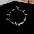 Elegant rose gold chain bracelet with mother-of-pearl butterfly flower charms and zircons - Gold