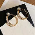 Close-up of elegant double-layered gold hoop clip-on earrings with sparkly zircons. - Clip-On Earrings / 1 Pair Pack / Gold