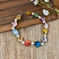 Detailed view of colorful shell and starfish beaded necklace for beach vacations. - Colorful