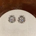 Close-up detail of vintage-style zircon and pearl clip-on earrings on display - Oval Artificial Pearl Ear Clip (HE32180) / One Pair / Silver