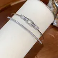 Close-up of elegant double-layer 18k gold plated bangle with sparkling cubic zirconia - White / Silver