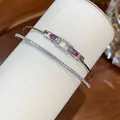 Detail shot of 18k gold plated bracelets with sparkling zircons and rainbow gemstones. - Colorful / Silver