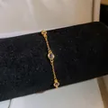 Elegant vintage gold-plated bracelet featuring purple oval zircon stones on a black display - Purple Oval Style / Gold