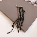 Detailed macro view of a silver safety pin brooch with long black beaded tassels - Safety Pin Long Tassel Style (Black/Silver)
