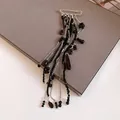 Close-up detail of a silver safety pin brooch featuring long black beaded chain tassels - Safety Pin Long Tassel Style (Black Waterdrop)