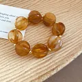 Holiday style amber acrylic beaded bracelet with elegant golden spacers for women - Bracelet / Brown