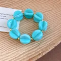Bright blue marbled acrylic circular bead bracelet with gold spacers for resort fashion style - Bracelet / Cyan
