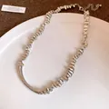 Detail shot of irregular silver chunky nugget necklace on a white plate - Irregular Metal Particle Clavicle Chain / Silver